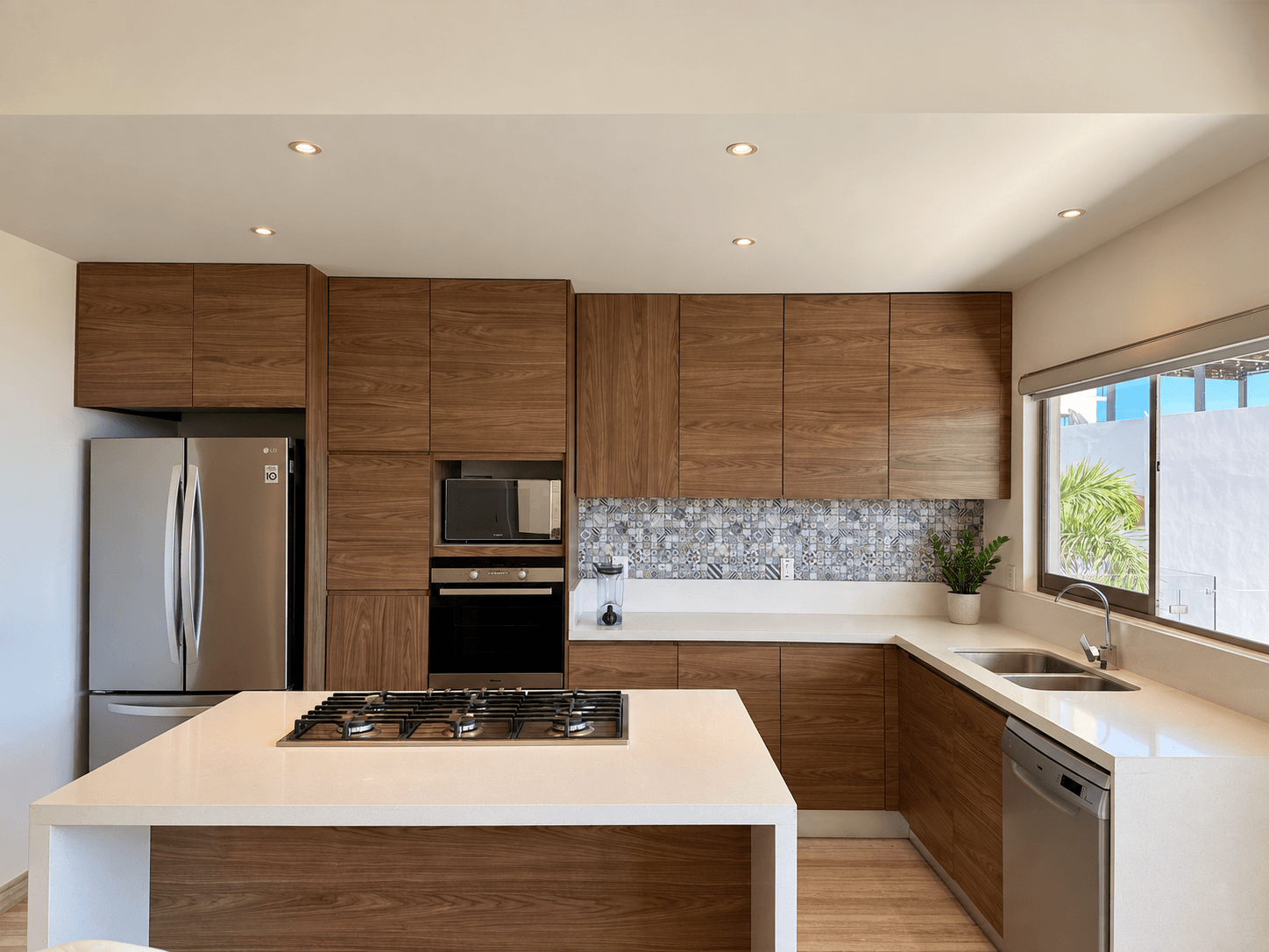 Kitchen equipped with island and built-in oven.
